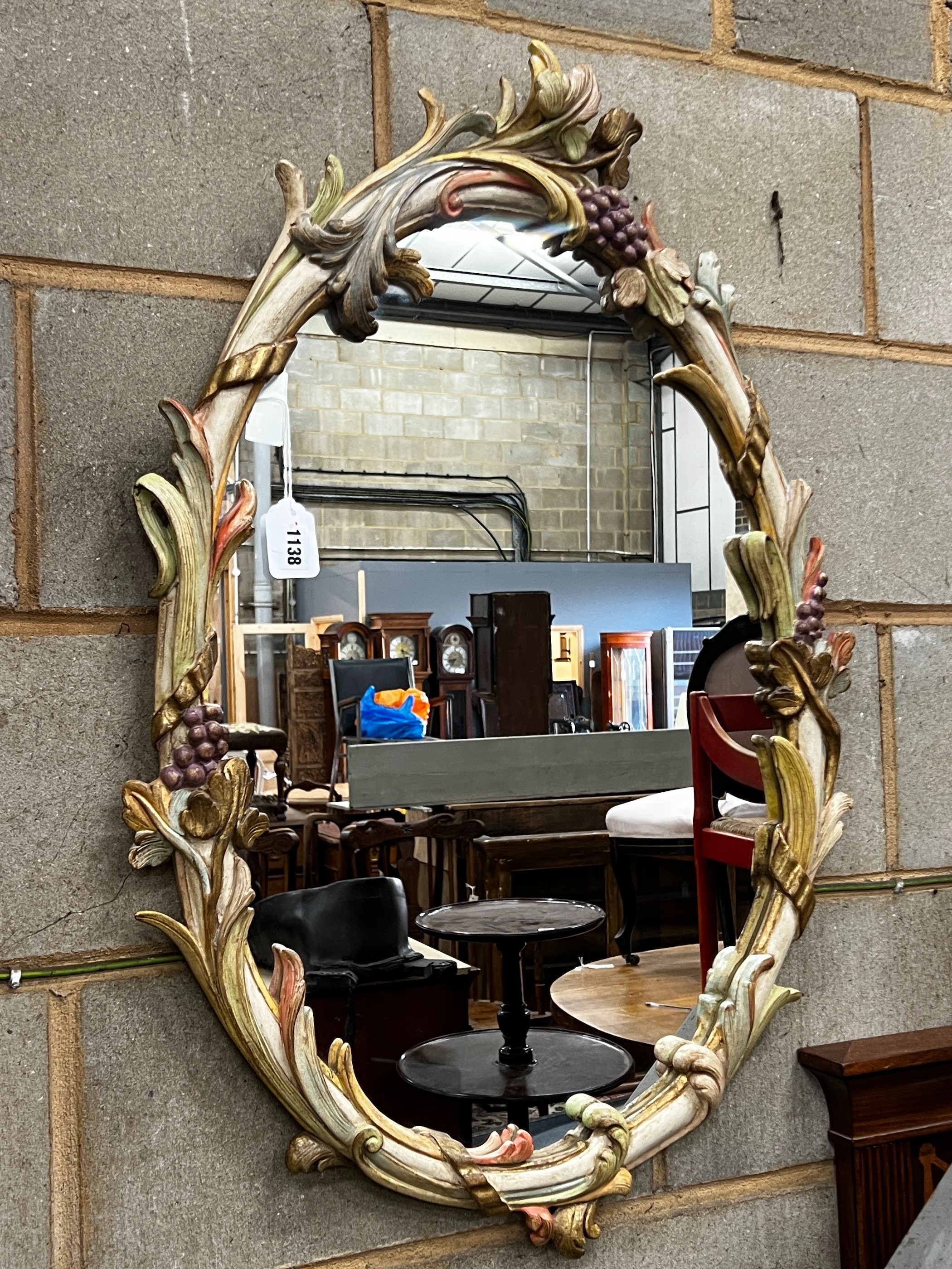 An oval painted frame wall mirror, width 58cm, height 90cm